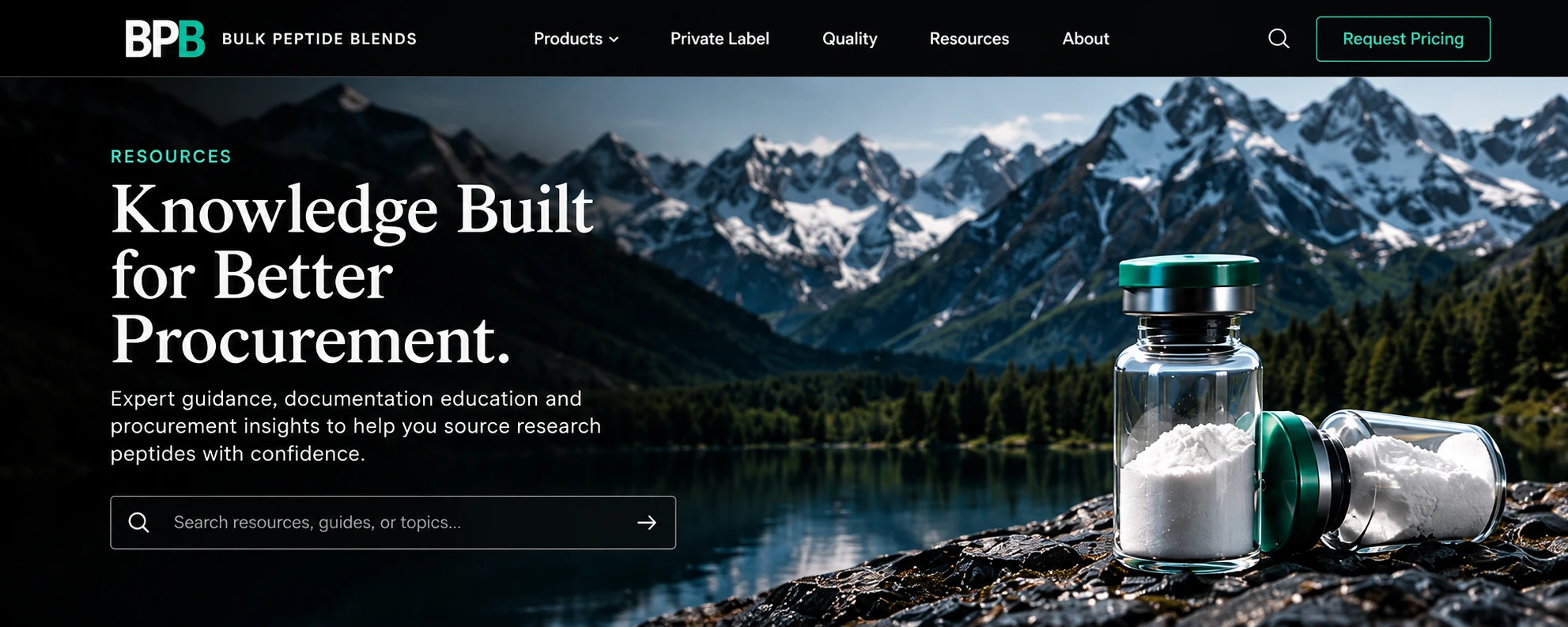 Two Bulk Peptide Blends research vials of white powder on a rock ledge above a mountain lake and snow-covered peaks.